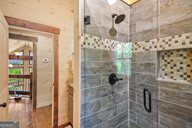 bathroom with a shower with shower door and wood-type flooring