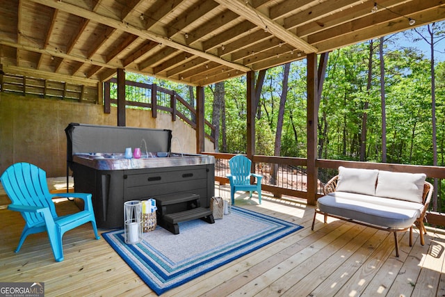 wooden deck featuring a hot tub