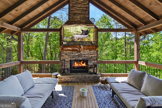 deck with an outdoor living space with a fireplace