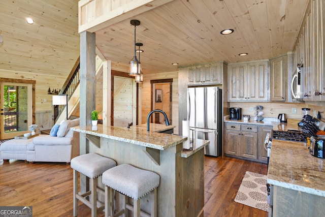 kitchen with dark wood-type flooring, a spacious island, wood walls, wooden ceiling, and stainless steel appliances