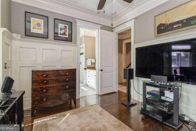 interior space featuring dark hardwood / wood-style flooring, ornamental molding, and ceiling fan