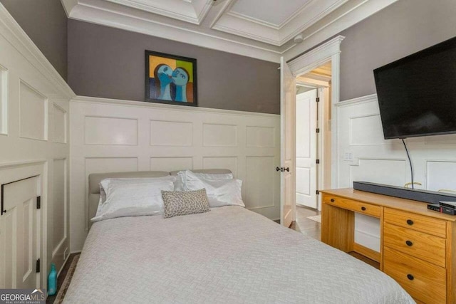 bedroom with hardwood / wood-style flooring, coffered ceiling, and crown molding