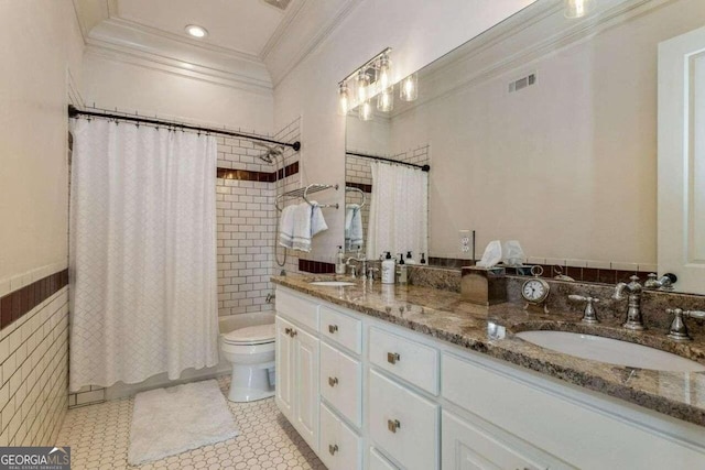 bathroom featuring toilet, ornamental molding, double sink vanity, and tile patterned floors