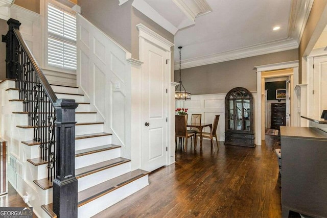 stairs with hardwood / wood-style flooring and crown molding