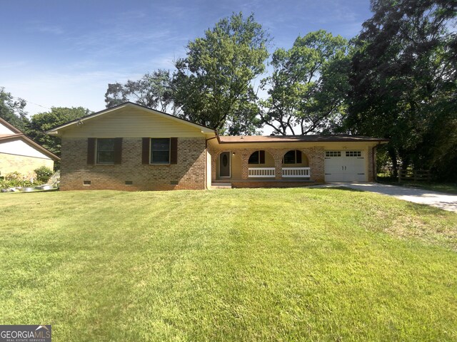 ranch-style house with a garage and a front yard