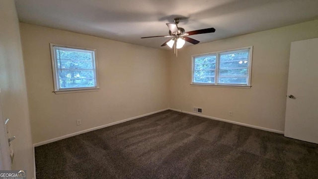 carpeted spare room featuring ceiling fan