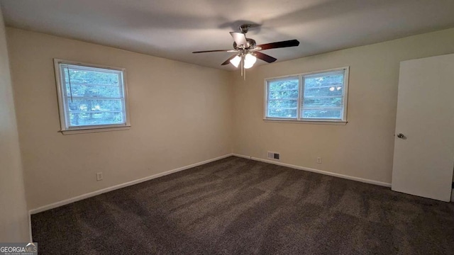 carpeted spare room featuring ceiling fan