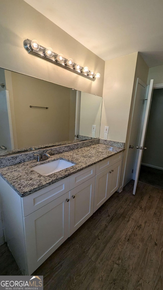 bathroom featuring vanity and wood-type flooring