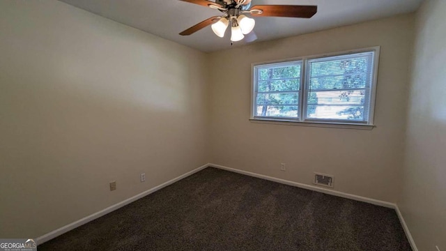 carpeted spare room with ceiling fan