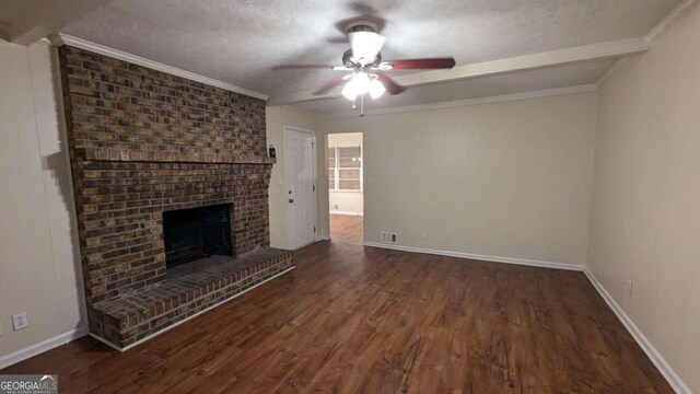 unfurnished living room featuring a textured ceiling, ceiling fan, dark wood-type flooring, and a brick fireplace