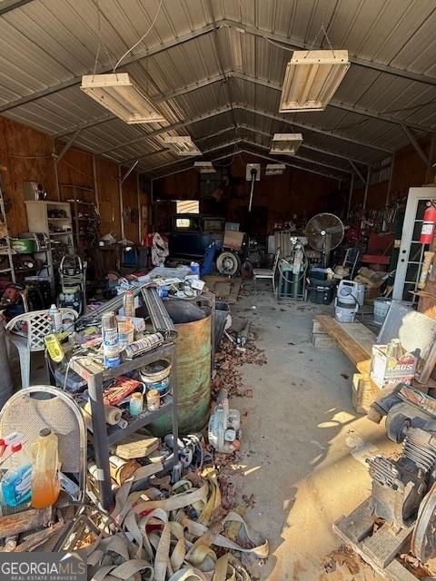 miscellaneous room featuring concrete floors and lofted ceiling