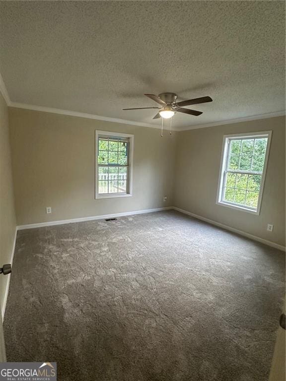 unfurnished room featuring ceiling fan, a textured ceiling, carpet floors, and crown molding