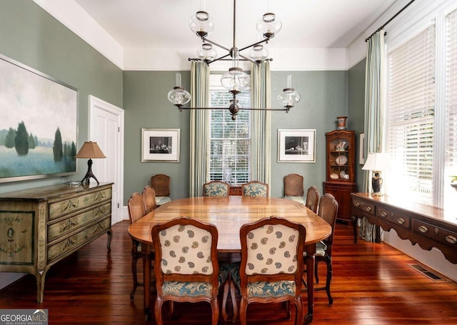 dining room featuring a notable chandelier and dark wood-type flooring