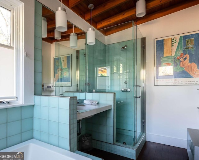 bathroom featuring independent shower and bath, wood ceiling, and beam ceiling