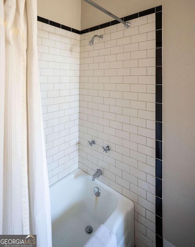 bathroom with shower / bath combo with shower curtain