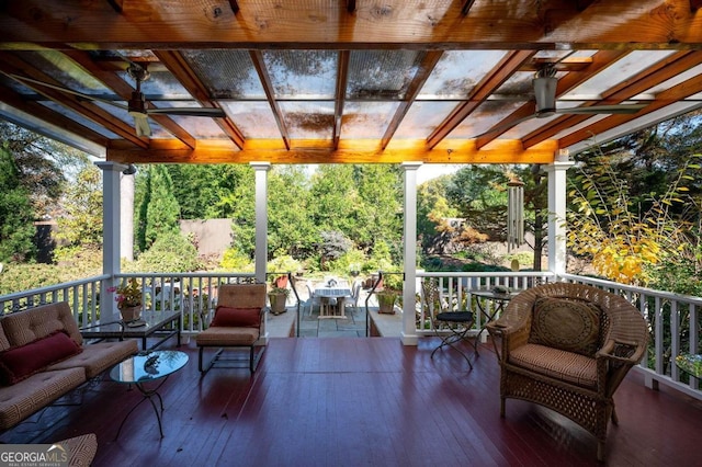 wooden terrace with an outdoor hangout area and a pergola