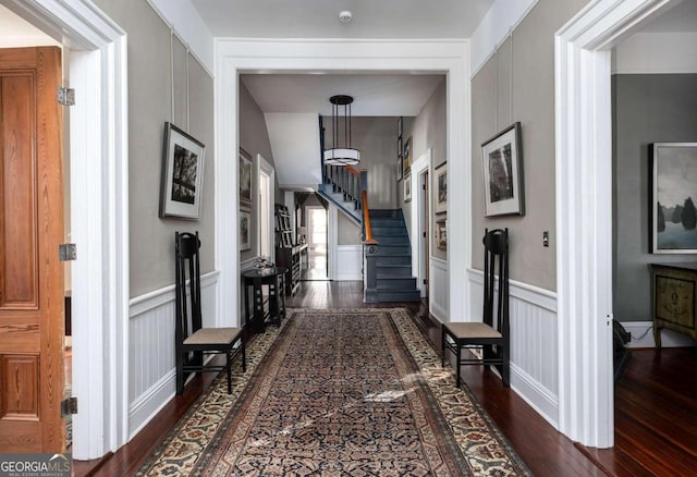 hallway featuring hardwood / wood-style flooring and vaulted ceiling