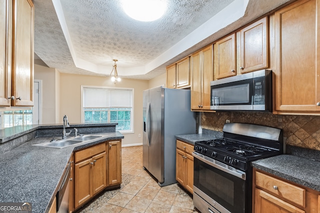 kitchen featuring light tile patterned flooring, sink, appliances with stainless steel finishes, a textured ceiling, and a raised ceiling