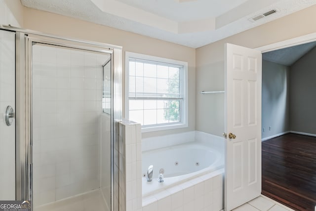 bathroom with separate shower and tub and wood-type flooring