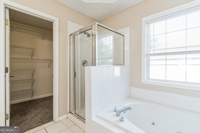 bathroom with tile patterned floors, plus walk in shower, and a healthy amount of sunlight