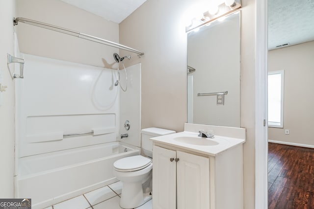 full bathroom with vanity, shower / tub combination, a textured ceiling, toilet, and hardwood / wood-style flooring