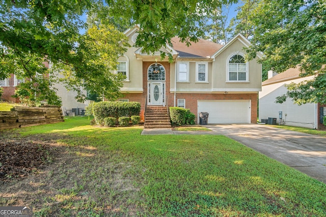 raised ranch with a front yard and a garage