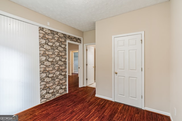 unfurnished bedroom featuring a textured ceiling and wood-type flooring