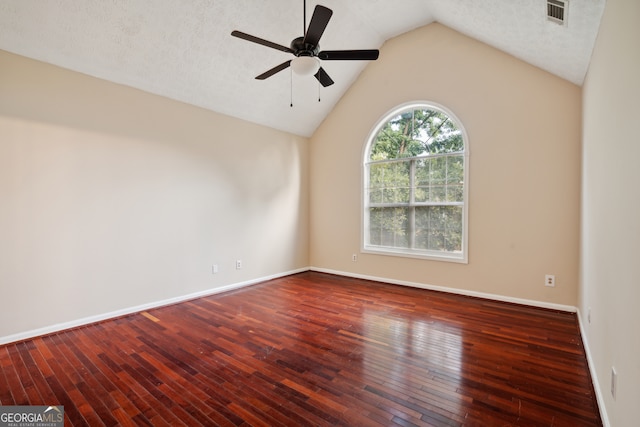 empty room featuring ceiling fan, a textured ceiling, lofted ceiling, and wood-type flooring