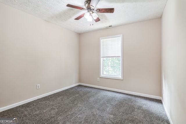 spare room featuring a textured ceiling, carpet flooring, and ceiling fan