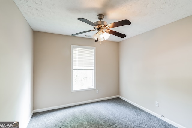 carpeted spare room featuring a textured ceiling and ceiling fan