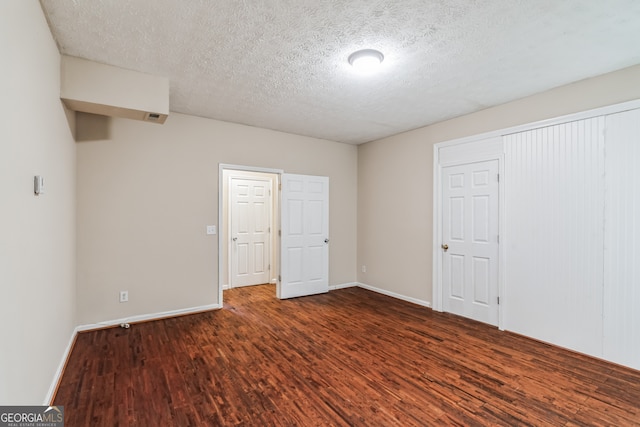 unfurnished bedroom with hardwood / wood-style flooring and a textured ceiling