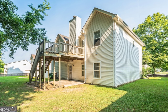 back of house with a lawn and a wooden deck