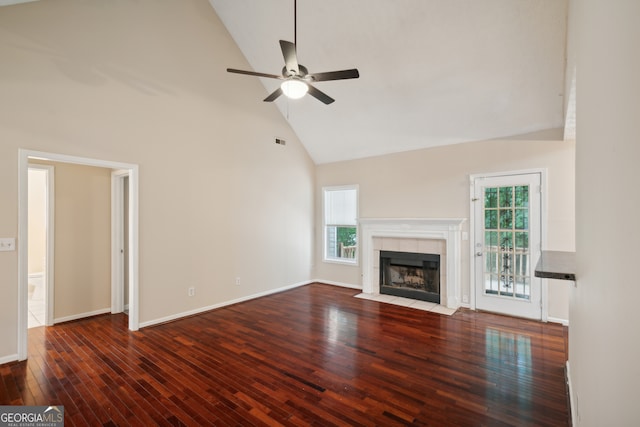 unfurnished living room featuring ceiling fan, a fireplace, high vaulted ceiling, and wood-type flooring