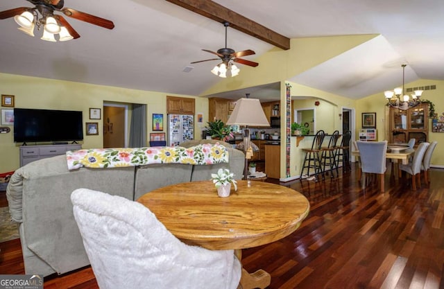 dining room featuring wood-type flooring, ceiling fan with notable chandelier, and lofted ceiling with beams