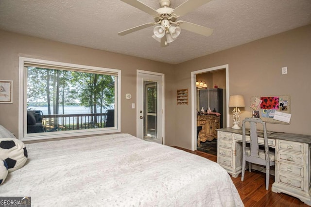 bedroom with ceiling fan, a textured ceiling, ensuite bath, and dark hardwood / wood-style floors