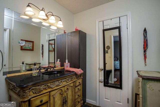 bathroom with a textured ceiling and vanity