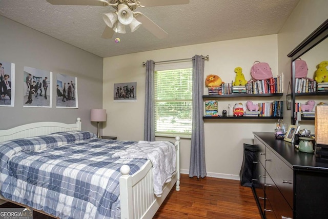 bedroom featuring ceiling fan, a textured ceiling, and dark wood-type flooring