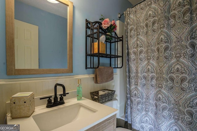 bathroom with backsplash, toilet, and vanity