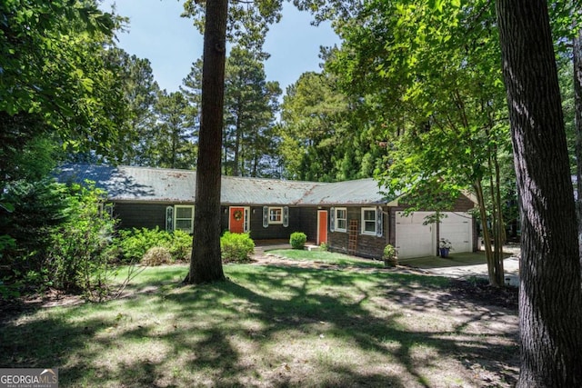 ranch-style home featuring a garage and a front yard