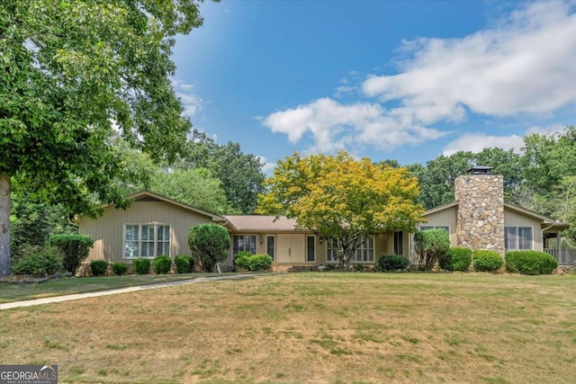 ranch-style home with a front lawn