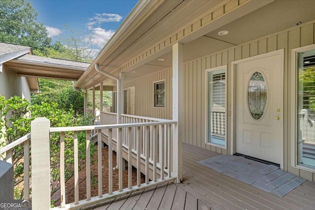 view of exterior entry with a wooden deck