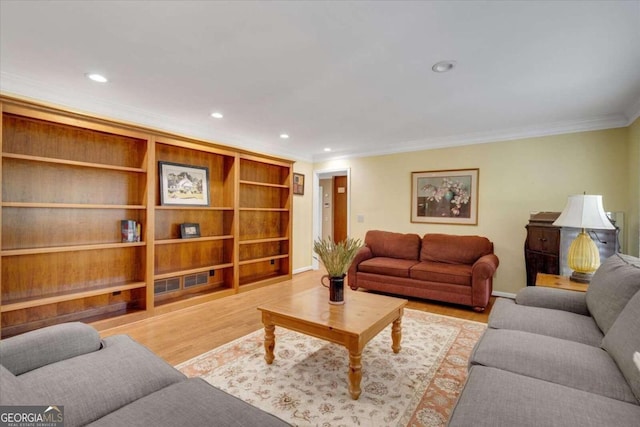 living room featuring light hardwood / wood-style flooring and crown molding