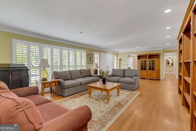 living room with light hardwood / wood-style floors and ornamental molding