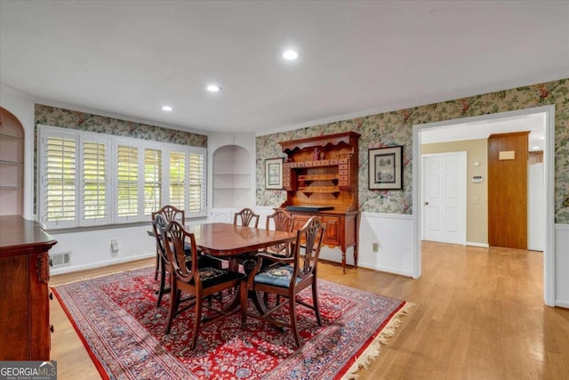 dining room with light hardwood / wood-style flooring and built in features