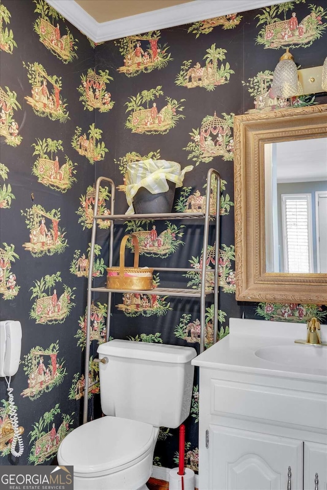 bathroom featuring ornamental molding, vanity, and toilet