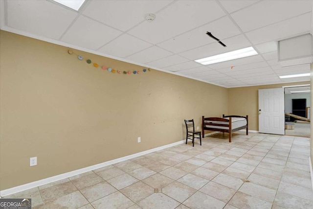 interior space with a paneled ceiling