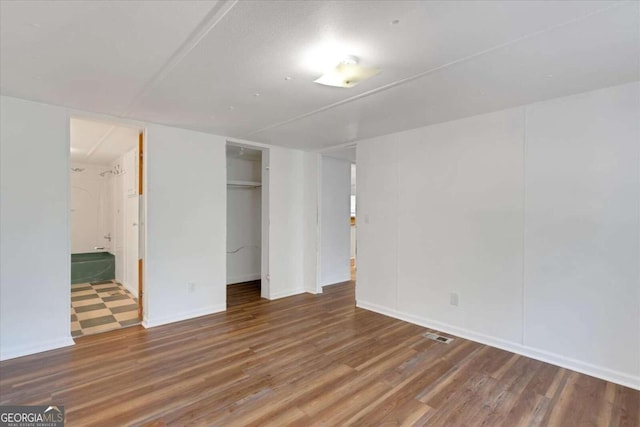 unfurnished room featuring hardwood / wood-style flooring