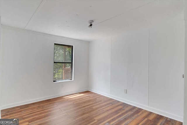 spare room with hardwood / wood-style flooring