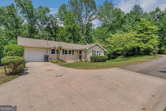 ranch-style home with a garage and a front yard