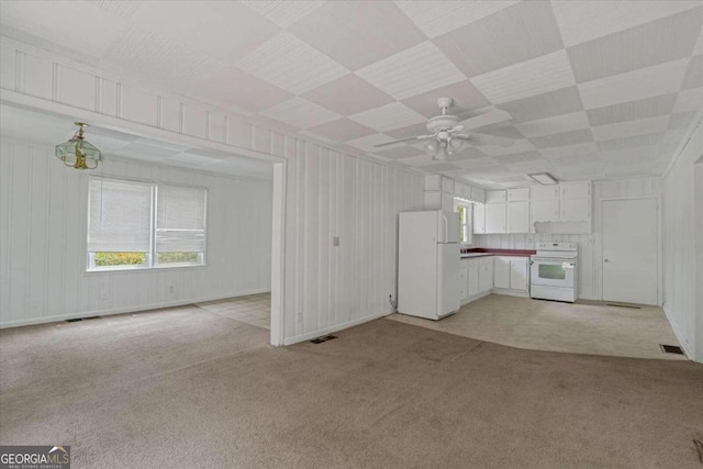 unfurnished living room featuring ceiling fan and light colored carpet